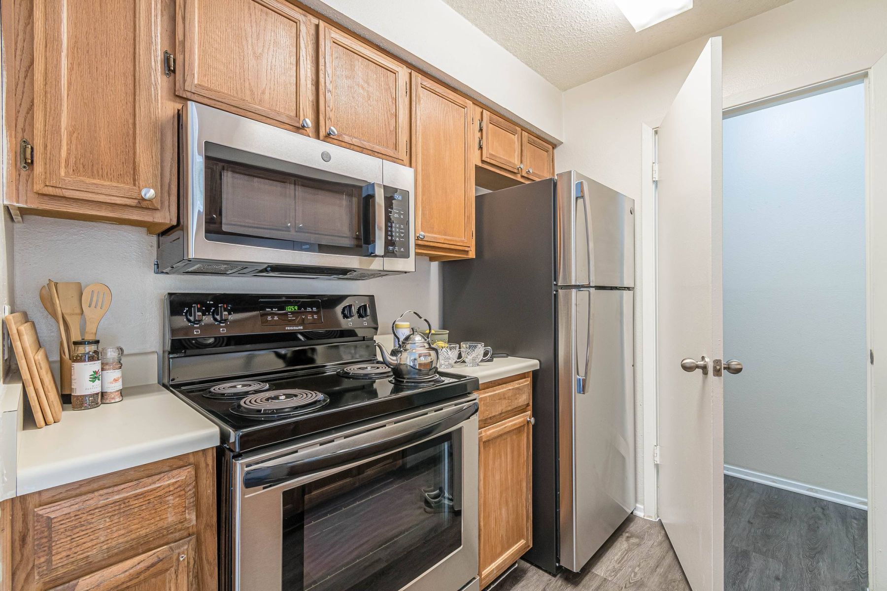 Luxury apartment kitchen with stainless steel appliances, granite countertops, and lots of storage space